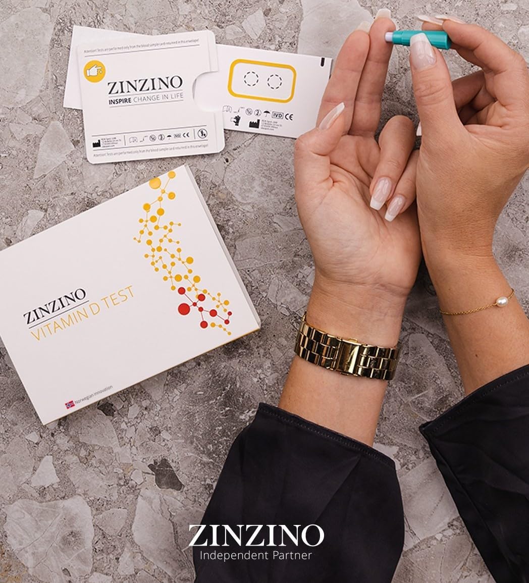 Woman using Zinzino Vitamin D Test kit to collect a finger-prick blood sample at home, with test materials and packaging visible on a gray stone surface.